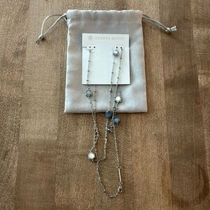 Brand New. Kendra Scott long silver necklace with grey,silver & violet stones.